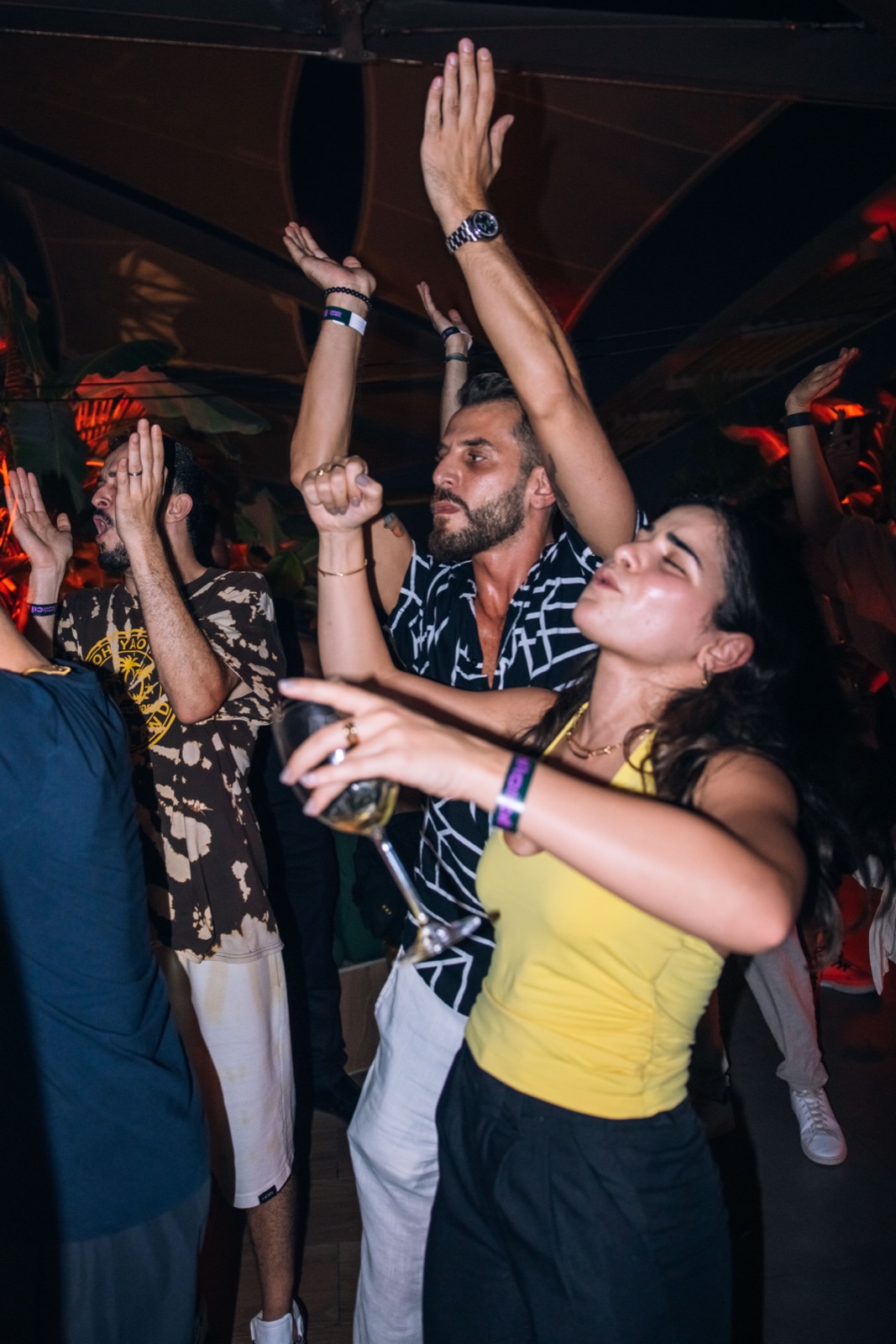 People dancing with their arms raised.