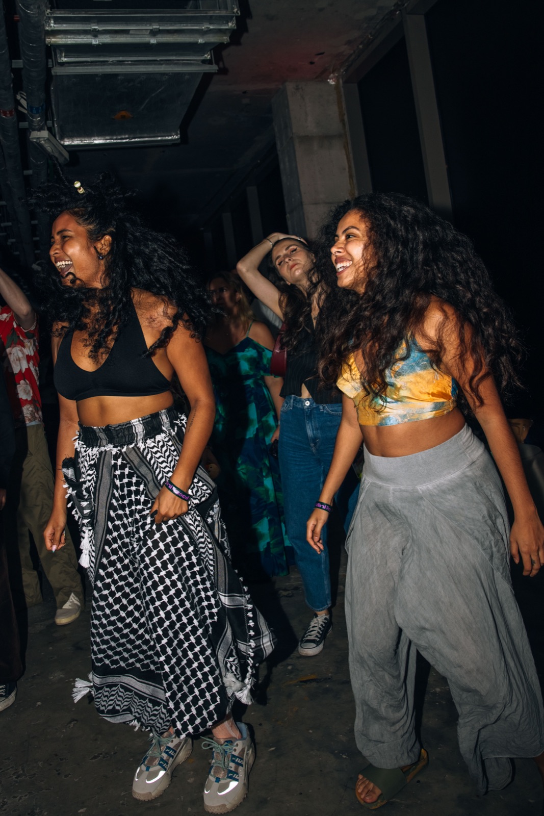 Two women dancing in patterned trousers.