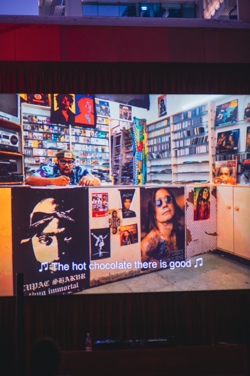 A stall wall covered in posters, sleeves and prints.