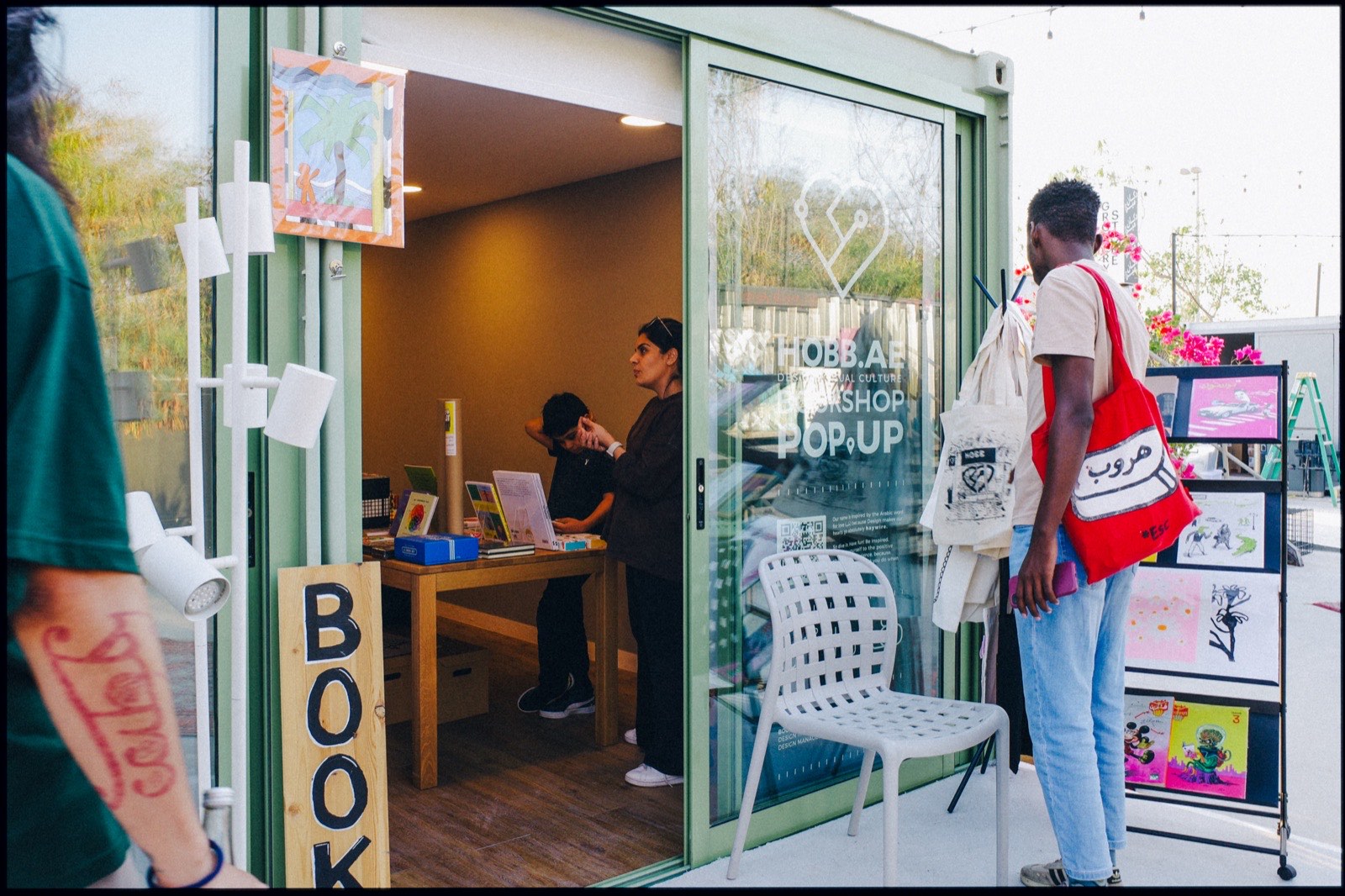 A shop in a converted container, with a books sign by the door.