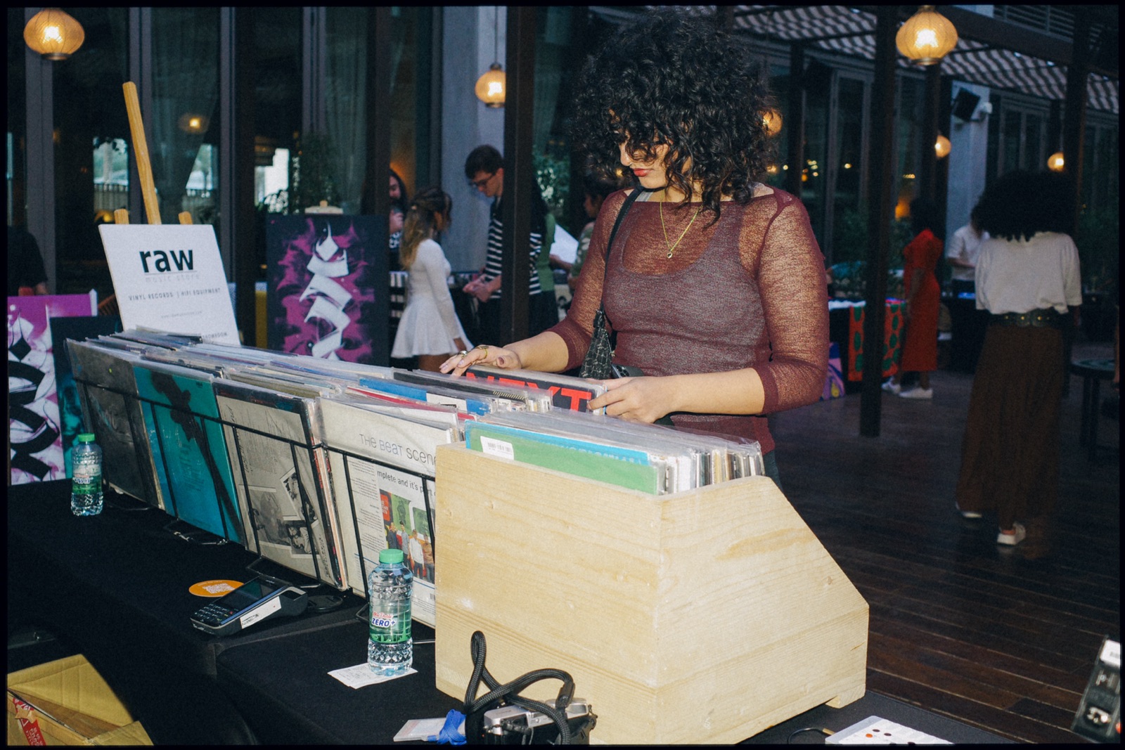A woman flicking through records at a stall.