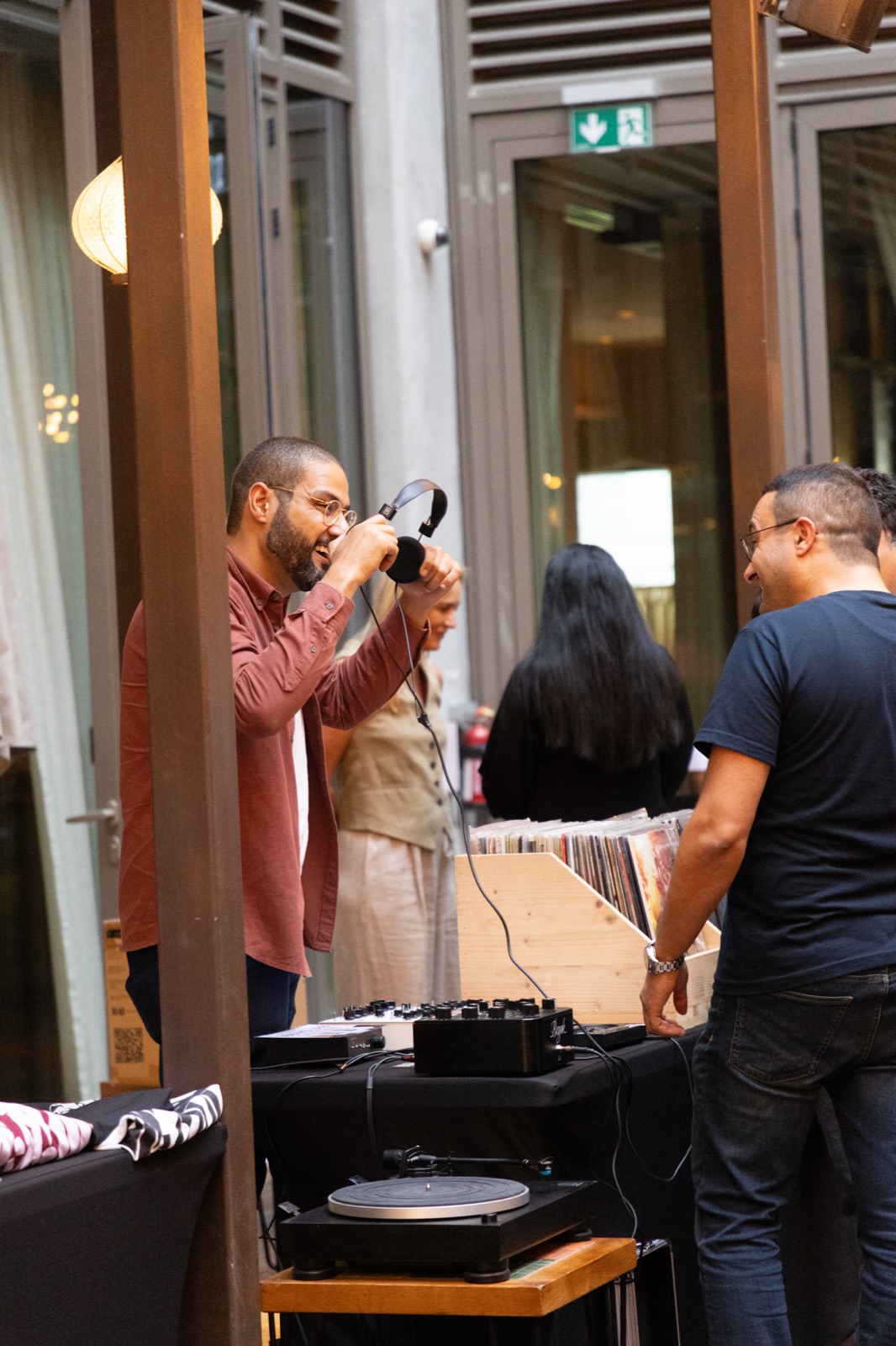 A man taking a photo of the record decks with a camera.