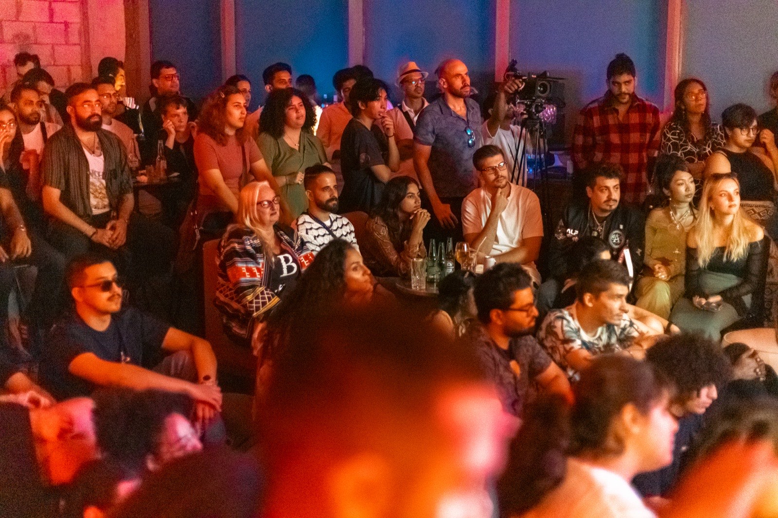A seated audience filling a room.